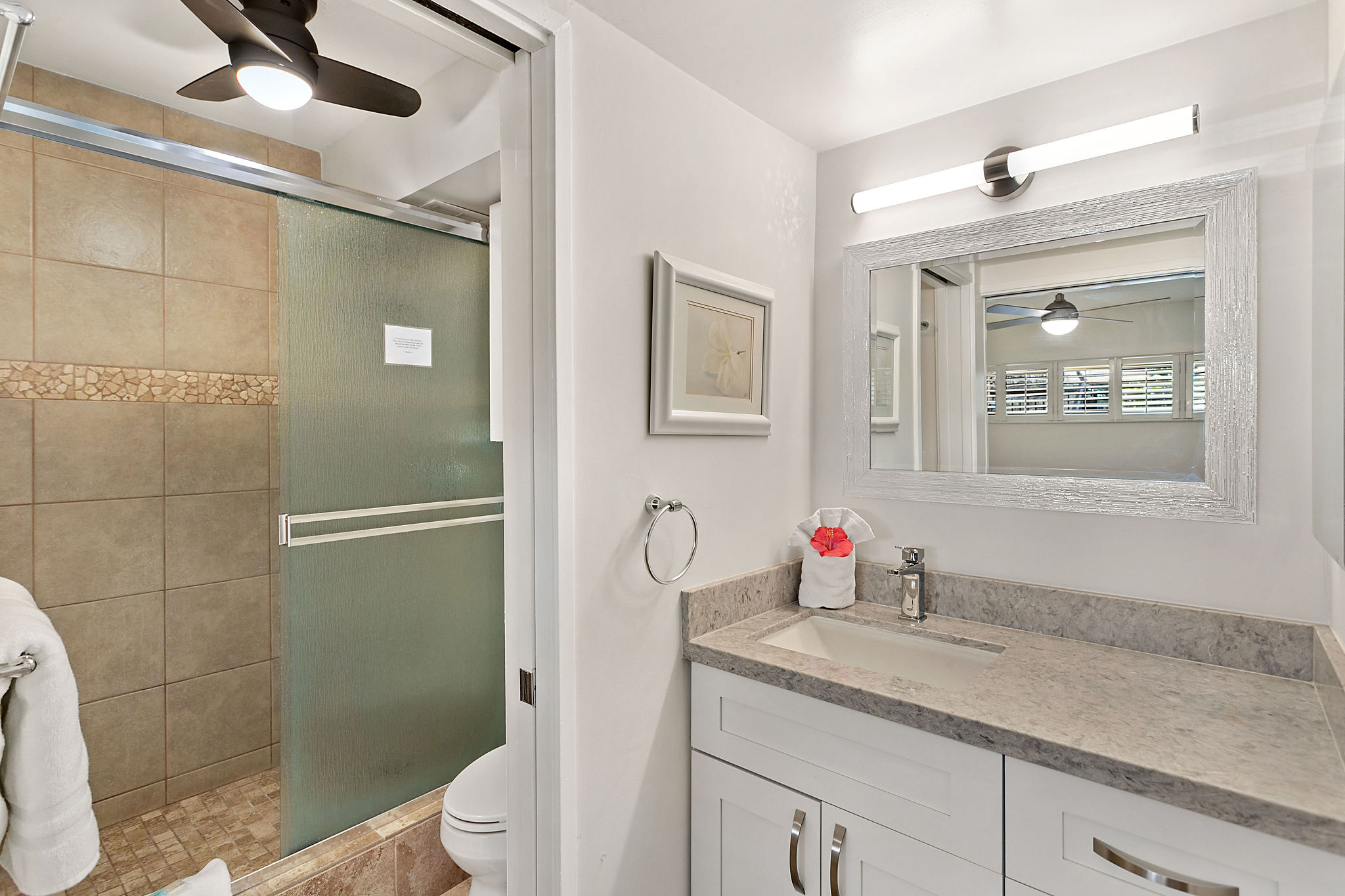 A pocket door separates the vanity from the shower