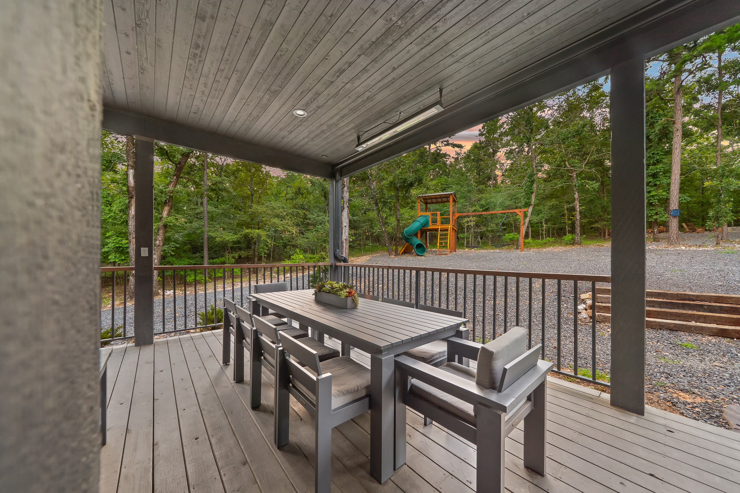 Large covered patio includes a gas fireplace, hot tub, smart TV, large spacious sectional, and outdoor dining area. Includes infrared heaters included as an extra bonus for all-weather enjoyment!