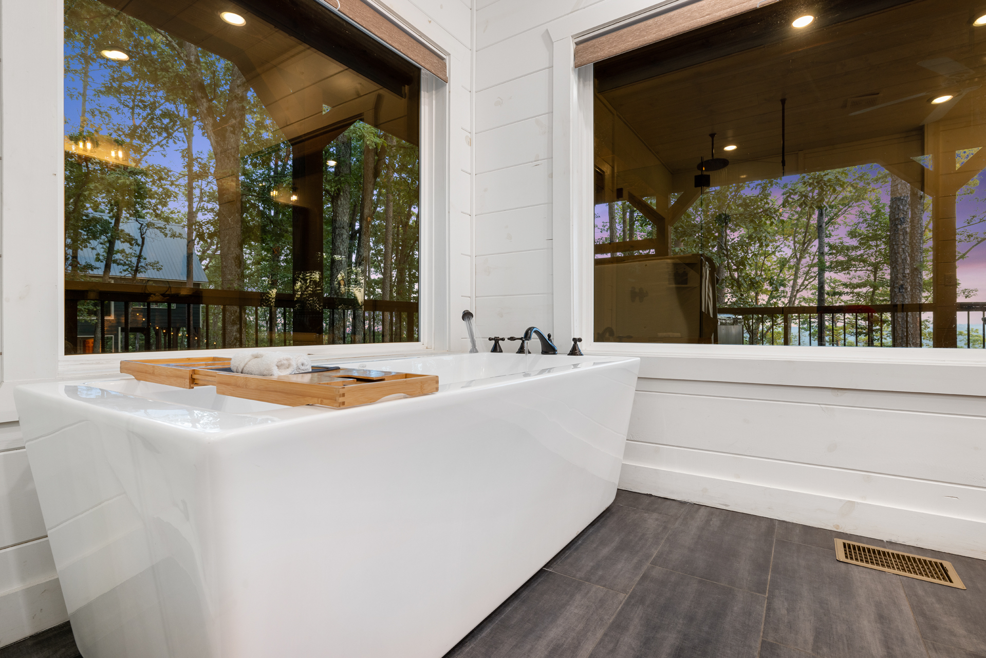 Freestanding soaking tub with peaceful forest views for ultimate relaxation