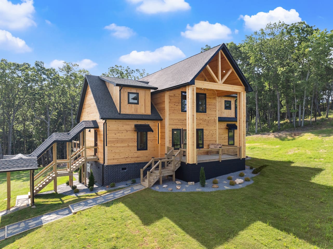 The elevated wraparound layout offers multiple stairways and easy access to nature all around.