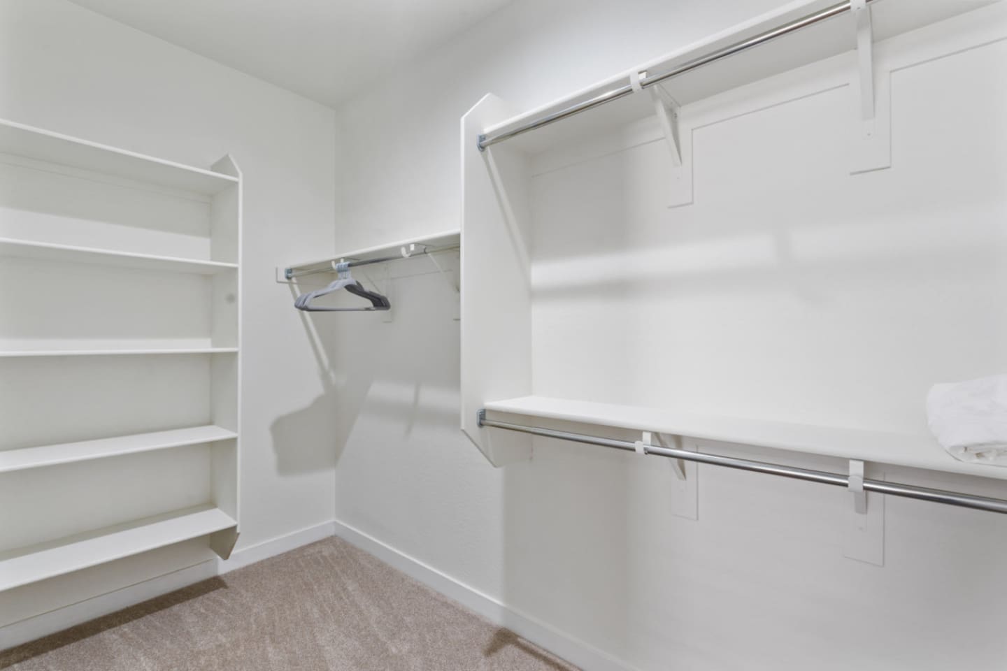 Walk-in closet with open shelving, hanging space, and room to unpack for short or extended stays.
