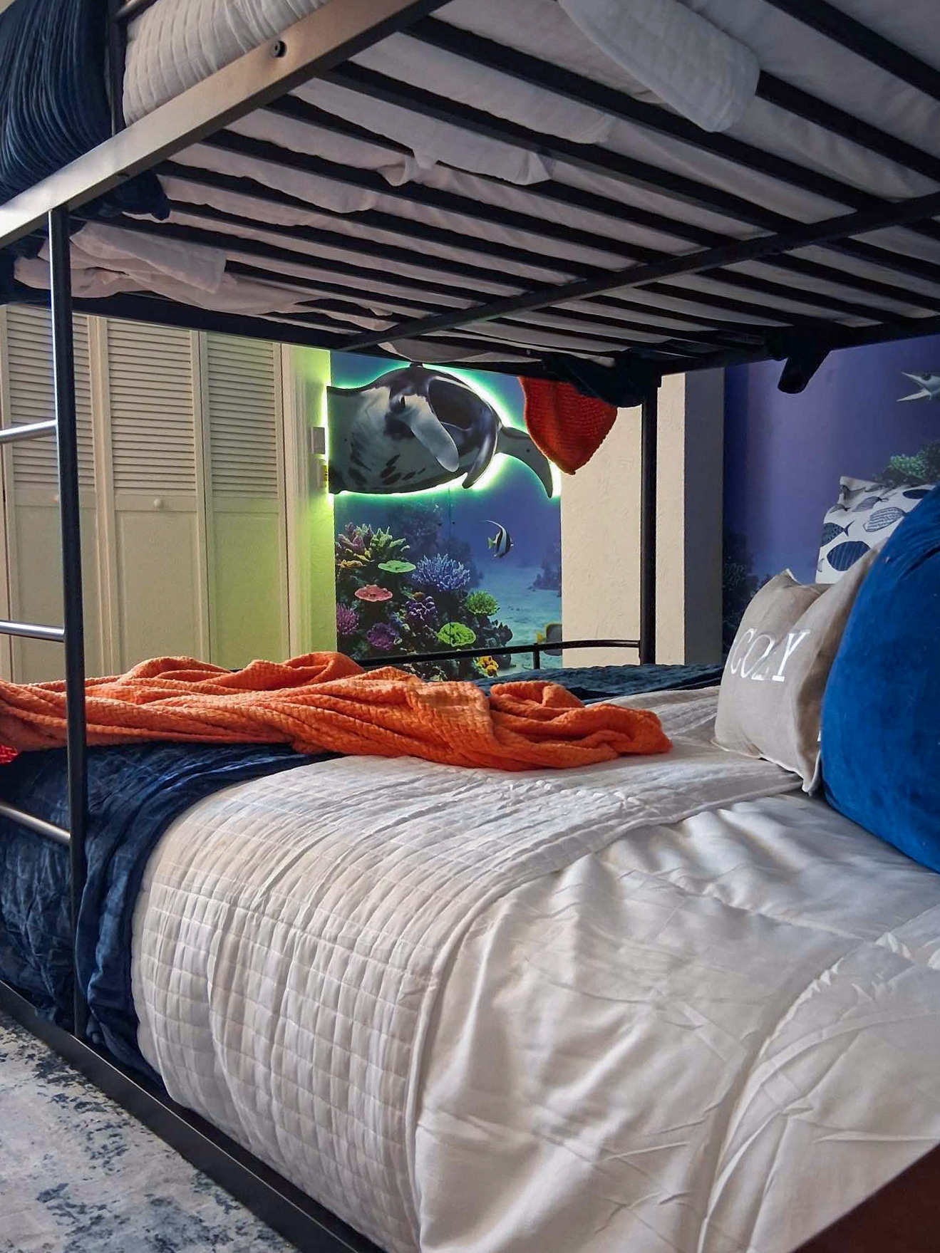 The fourth bedroom is the Aquarium room, including queen bunk beds and twin bunk beds, sleeping up to 6 people comfortably.