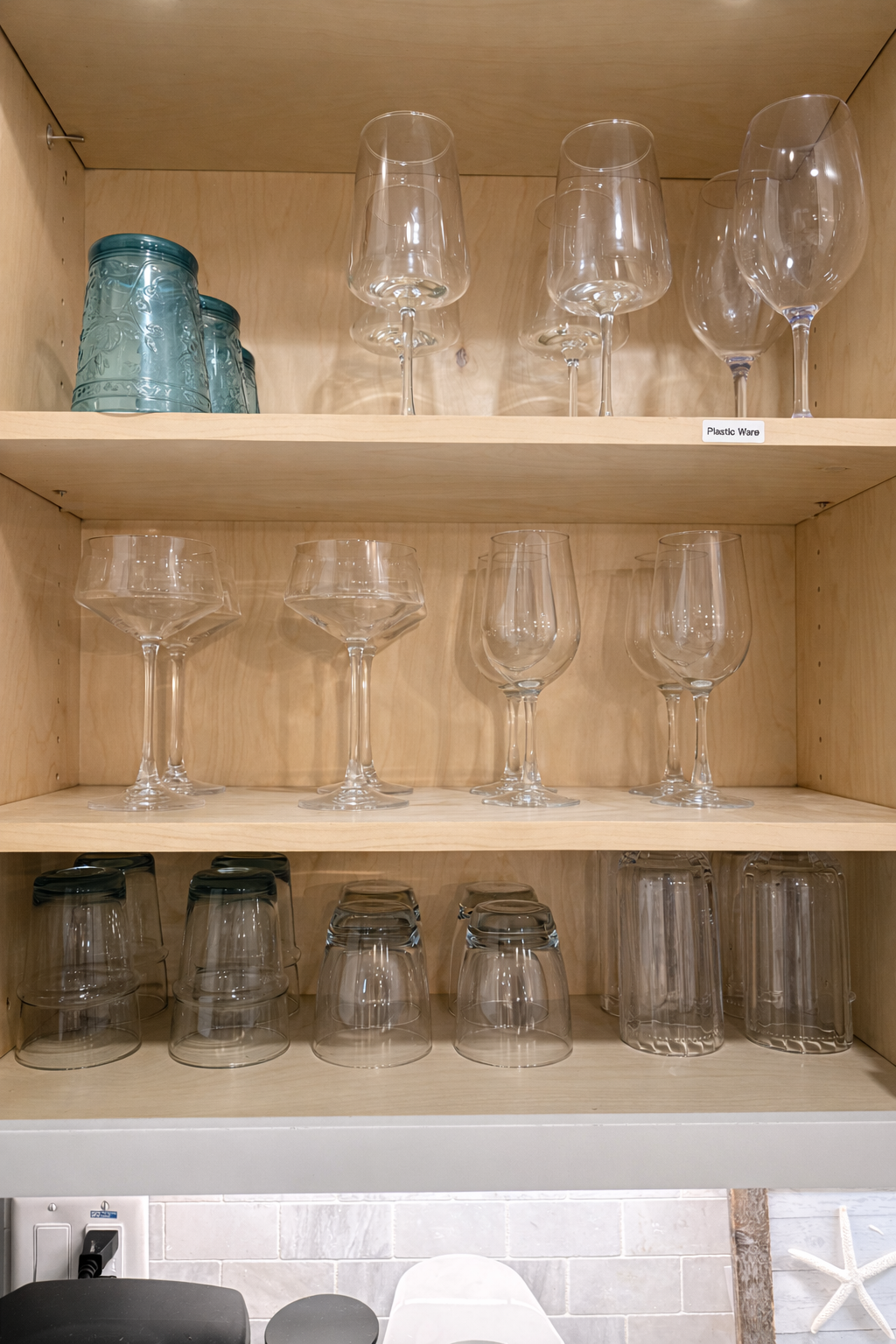 An array of both plastic and glass ware to enjoy your favorite beverage inside, on the patio or pool deck.