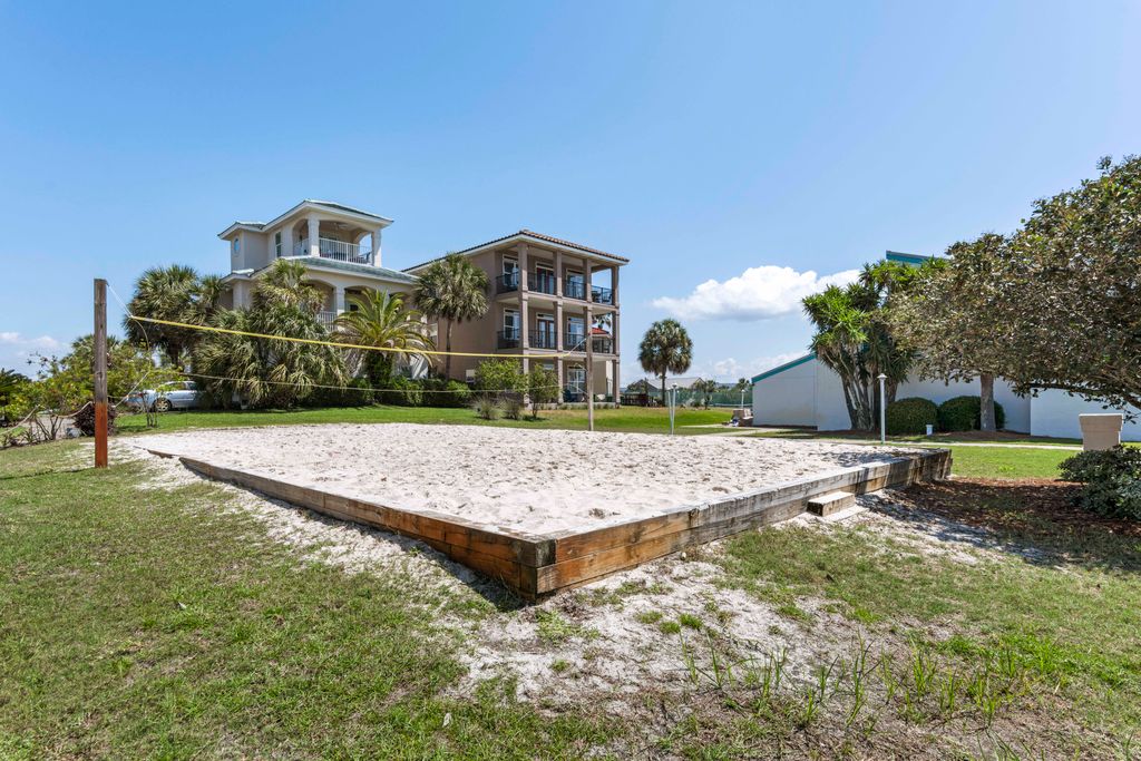The volleyball court is just steps away from the house, with the house visible in the background.