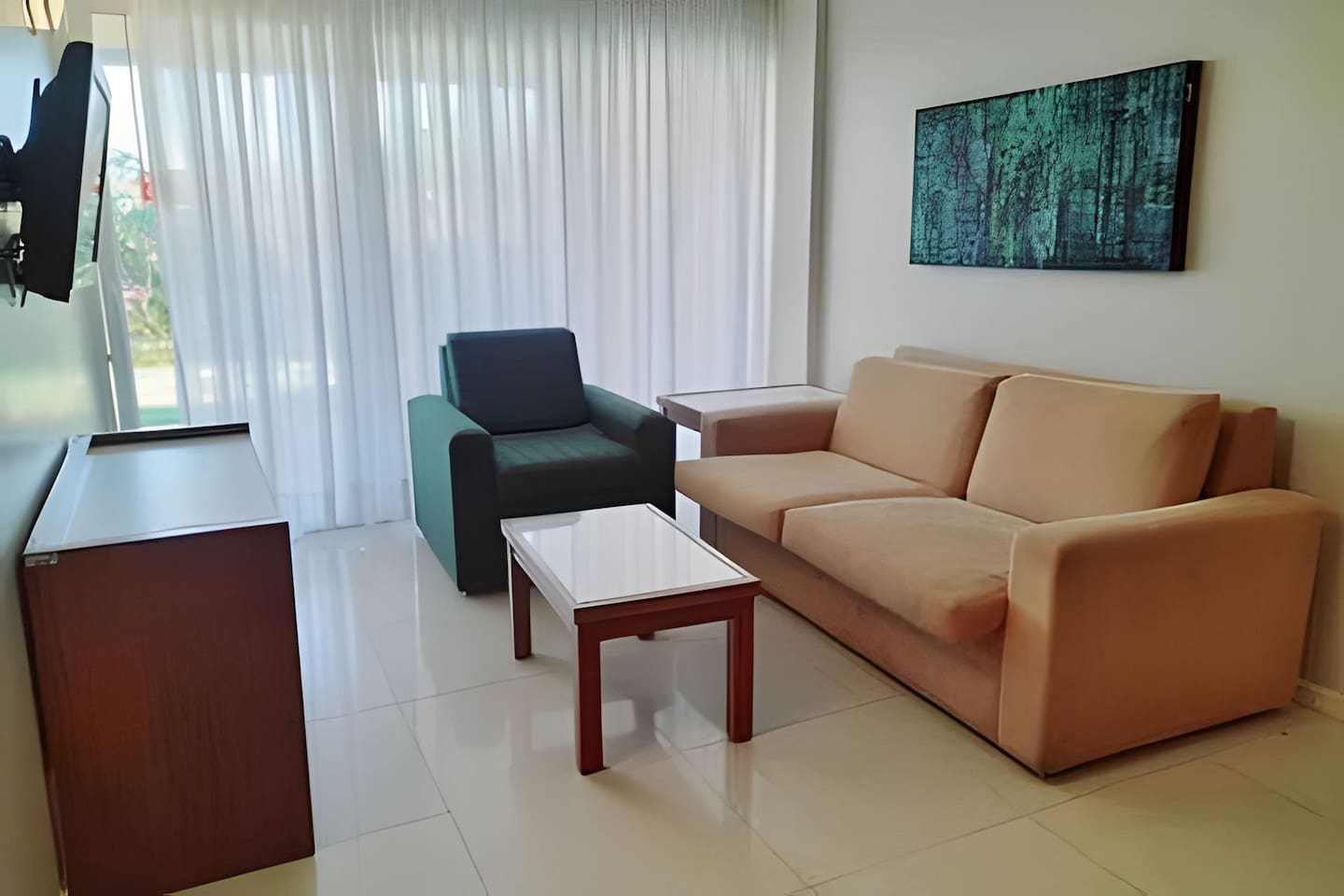 Relax and unwind in the living room, full of natural light. 