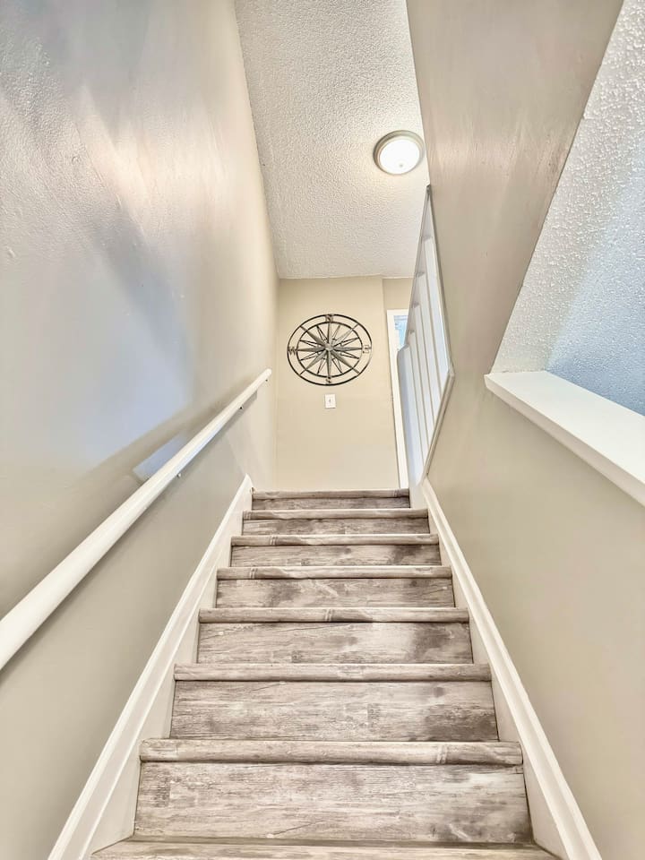 Stairway to Adventure: Brightly lit stairs leading you to your seaside getaway!