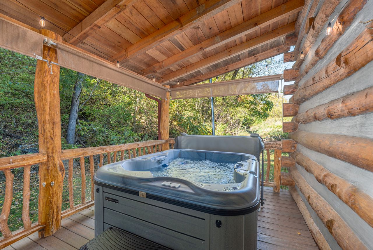 The hot tub is located on the back porch and offers privacy for guest to enjoy a relaxing soak. 