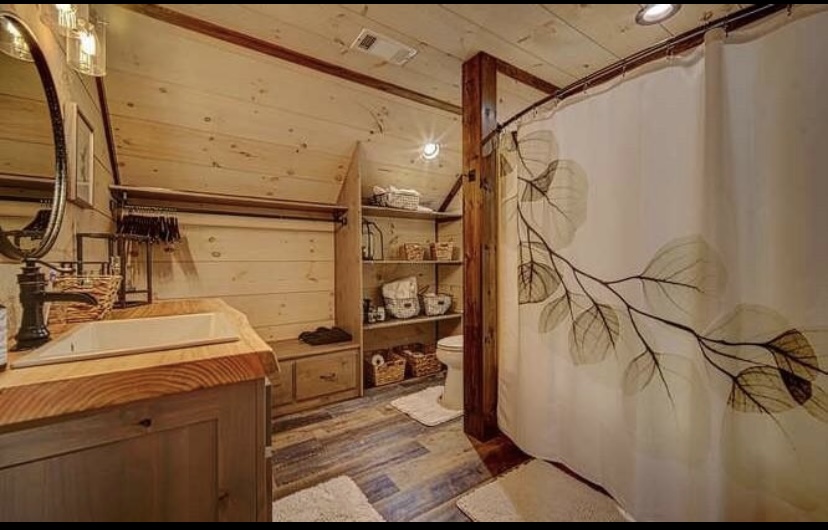 Full bath in garage apartment. Live edge vanity with additional rustic details.