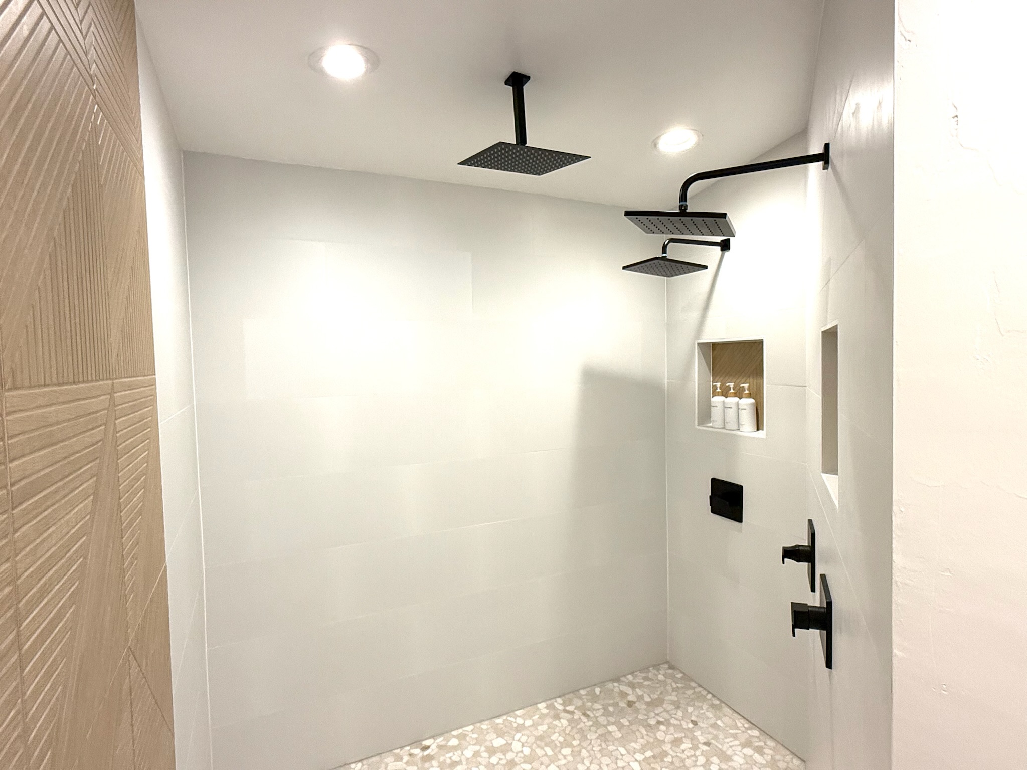 Oversized spa-inspired Primary sanctuary shower with three large rain shower heads