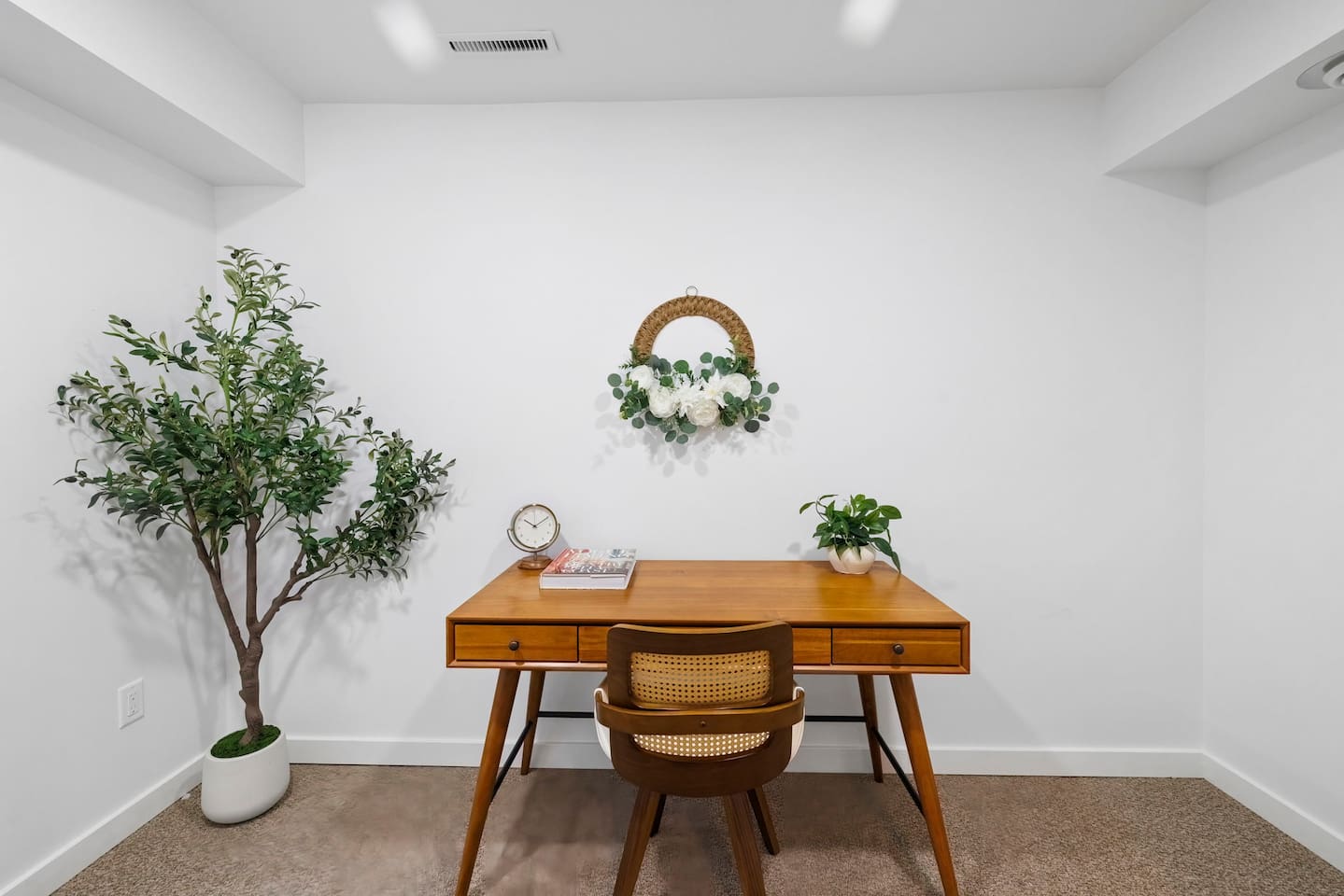 Dedicated workspace with a spacious wooden desk, a comfortable chair, and a quiet, calming setup for remote work.