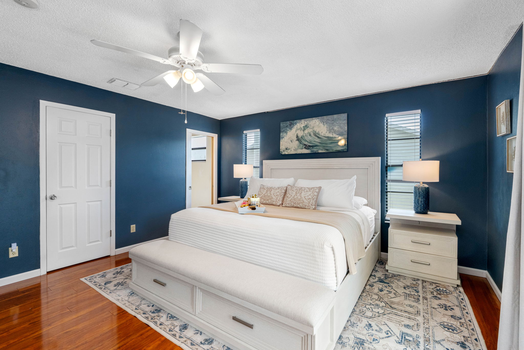 A stylish and serene primary bedroom designed with comfort and class in mind.