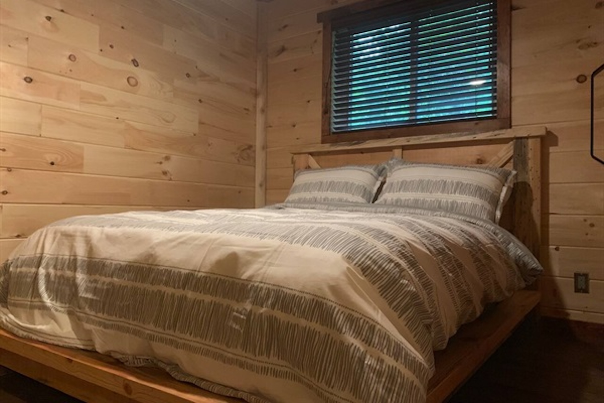 Cozy bedroom with window and warm wood interior