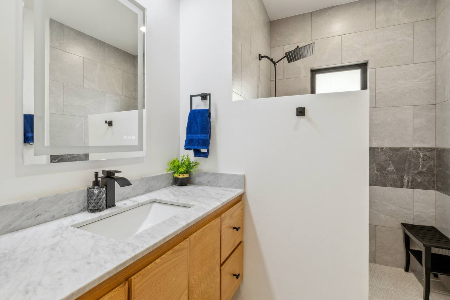 Guest bathroom with 3-way LED lit anti-fog mirror with walking shower.