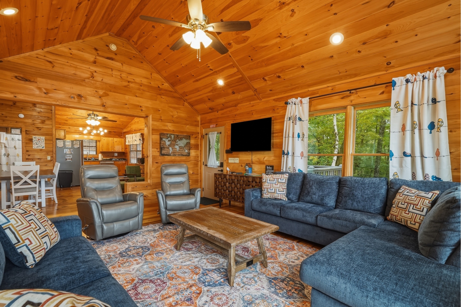 Living area with lots of seating, fire place and smart TV
