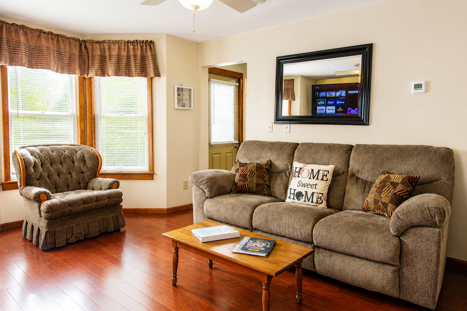 Living room with plenty of seating for everyone.  The comfy oversized chair is great to curl up with a book or a cup of coffee and your thoughts before you start your busy day!