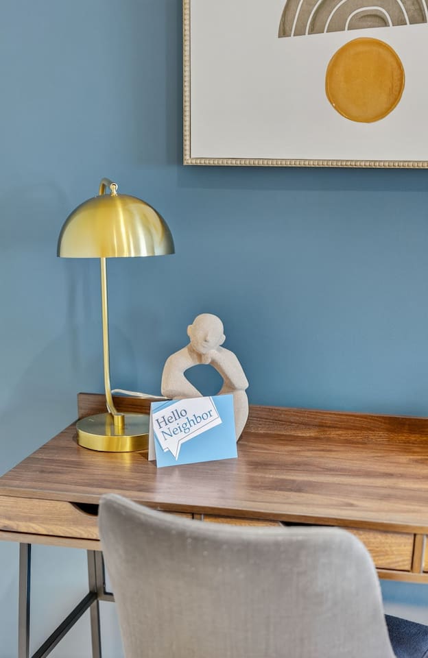 Stay productive with a dedicated desk setup featuring modern artwork, a gold lamp, and high-speed Wi-Fi. Ideal for remote work, study, or creative projects, this workspace ensures comfort and focus during your Des Moines stay.