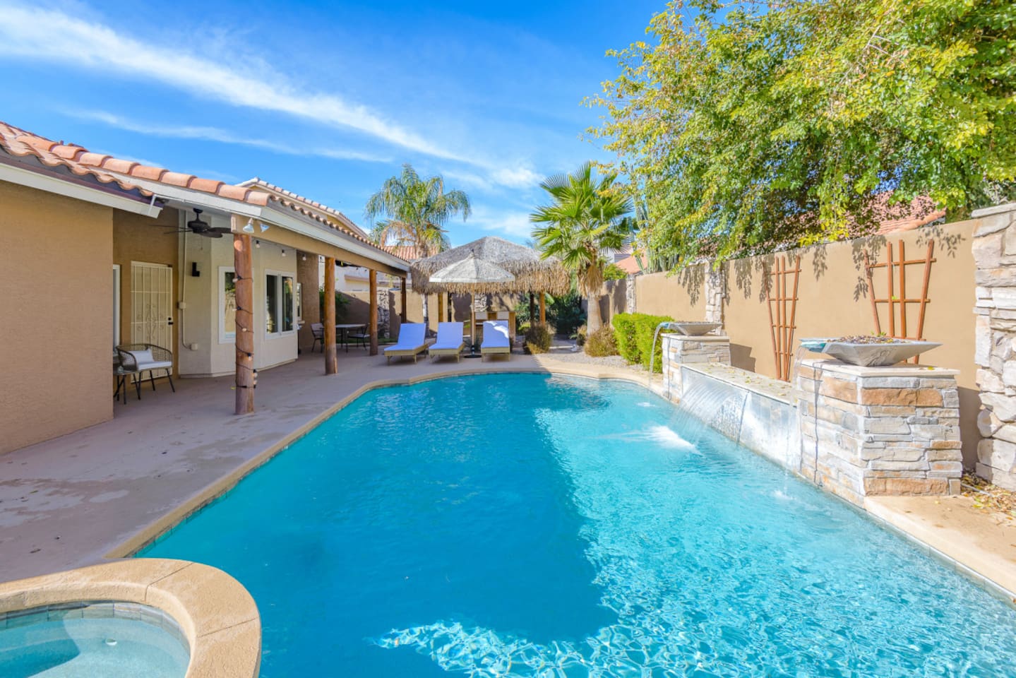 Backyard pool and spa with lounge chairs, water features, and space to enjoy the Arizona sun.