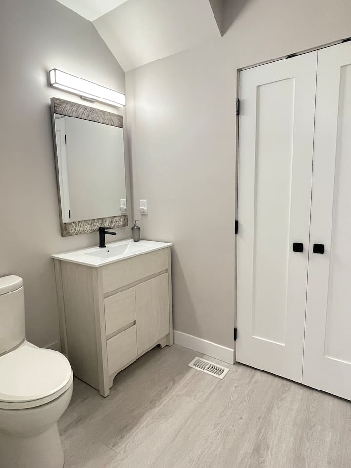 Main level Bathroom. Attached is the door to the laundry room where you can find washer, dryer, ironing board and light cleaning supplies.