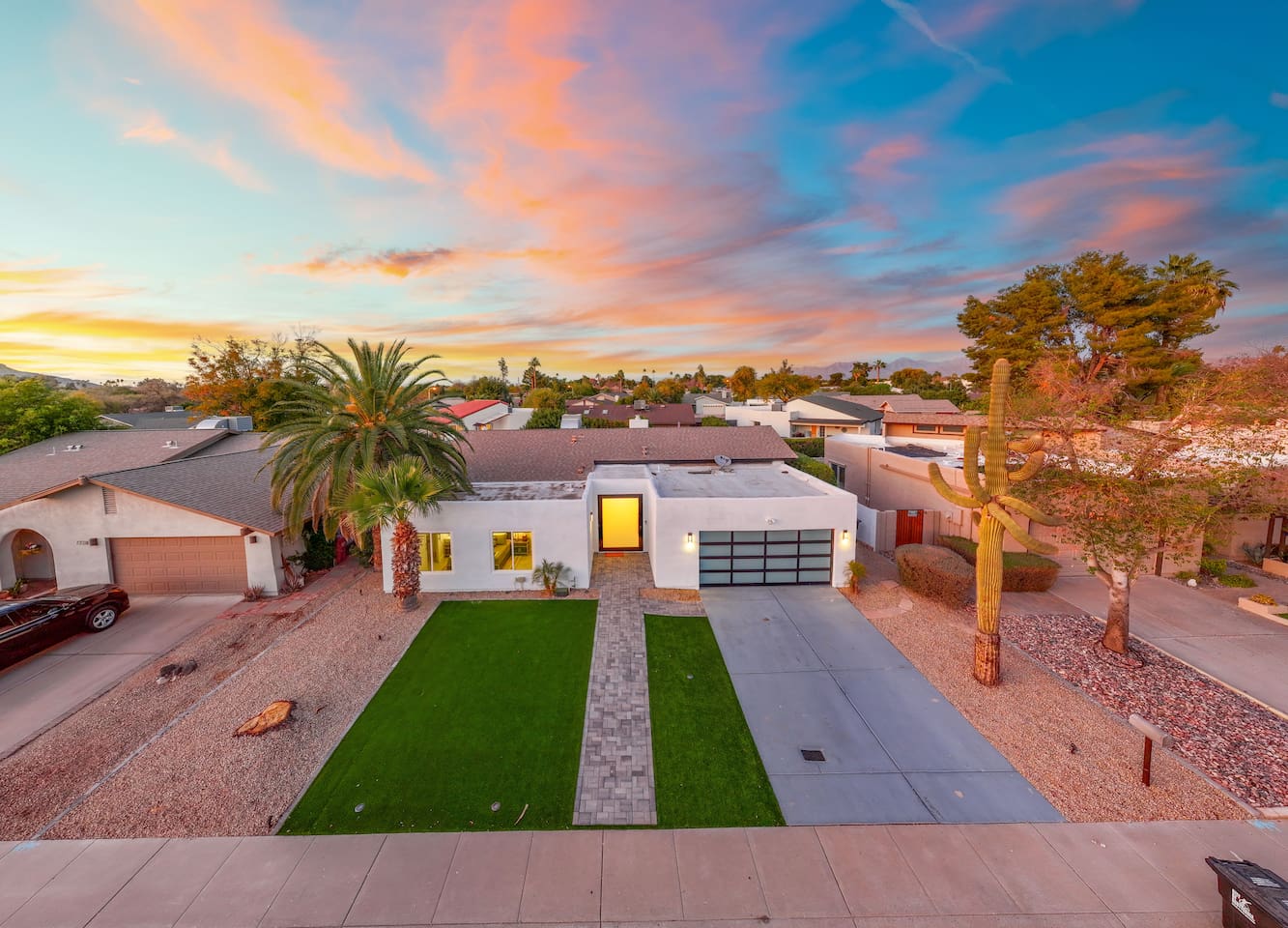 Catch the sunset glow as this modern desert gem lights up the neighborhood.

