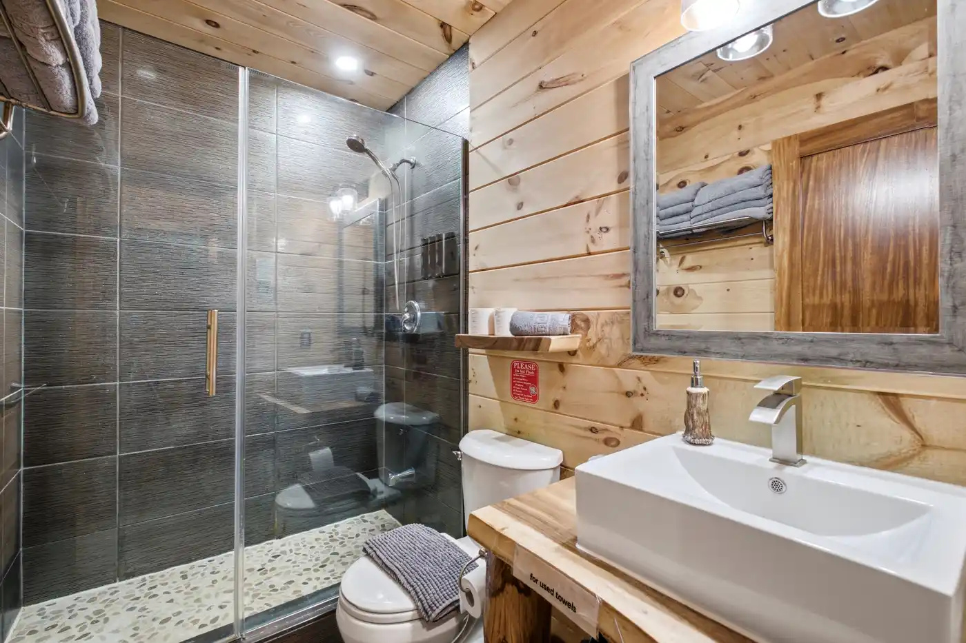 Modern bathroom with glass shower and bright vanity
