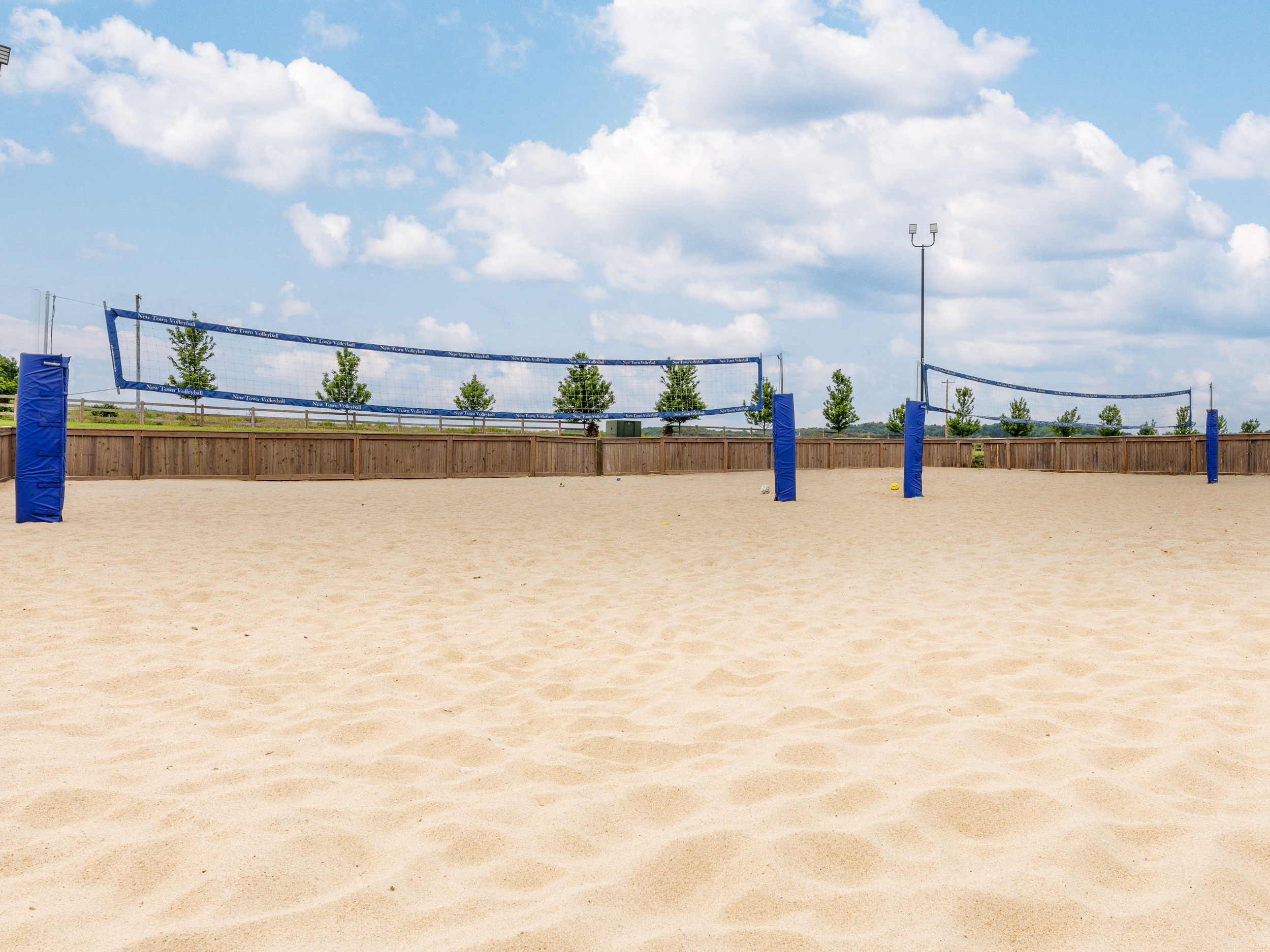 Enjoy the community sand volleyball court, perfect for a casual game with friends or an afternoon in the sun just steps from the neighborhood green spaces.