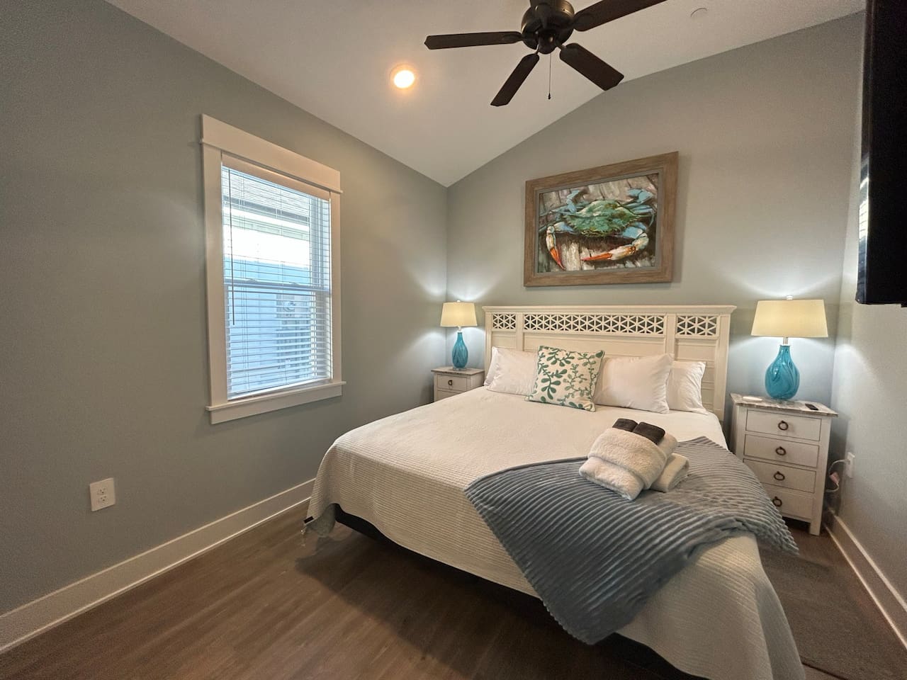 King bedroom is well decorated and has cathedral ceilings.
