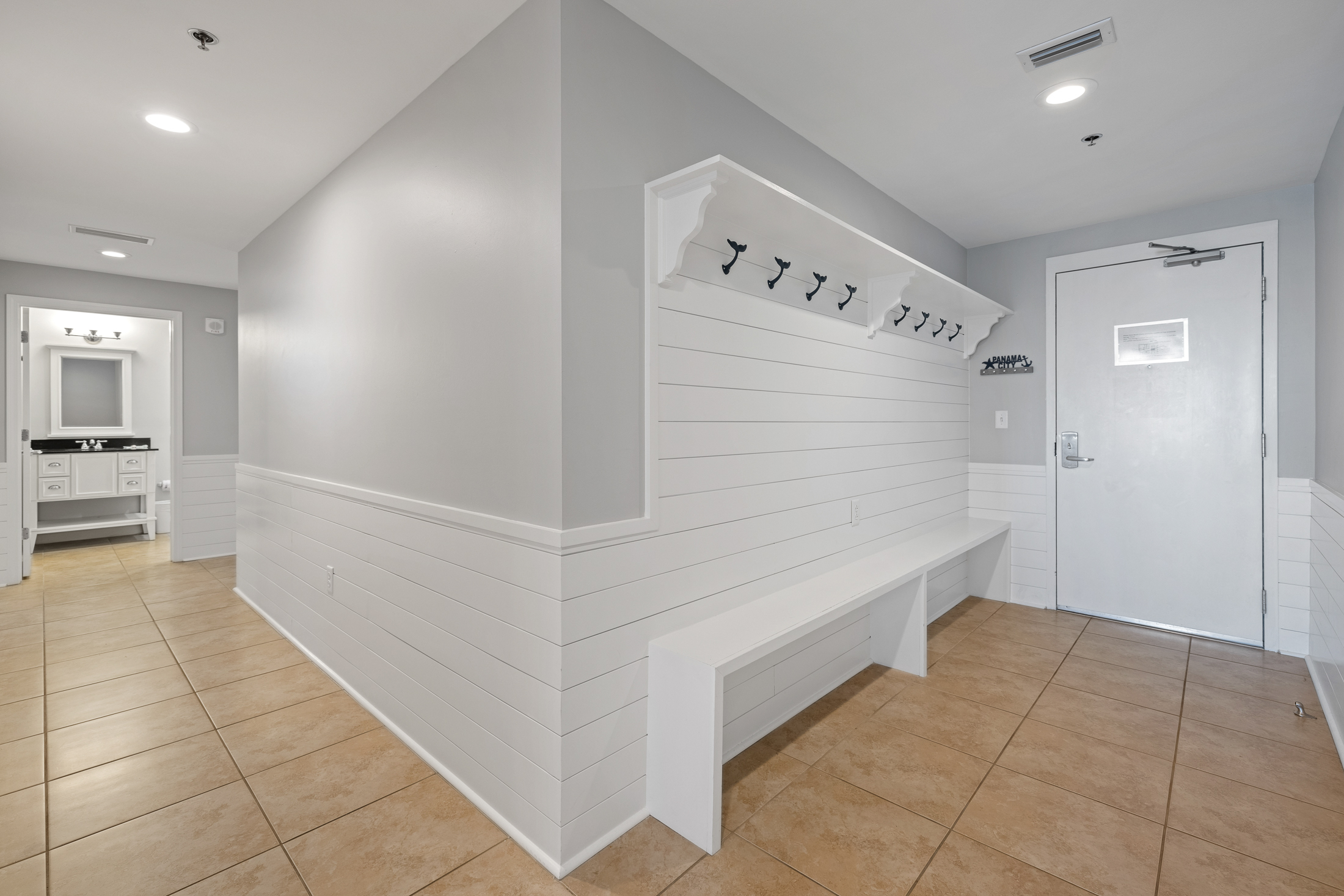 An organizer's dream come true!  This 10+ foot long hallway built-in provides plenty of storage to hang your beach bags, put up your keys on the custom "Panama City" key holder and store your flip flops.