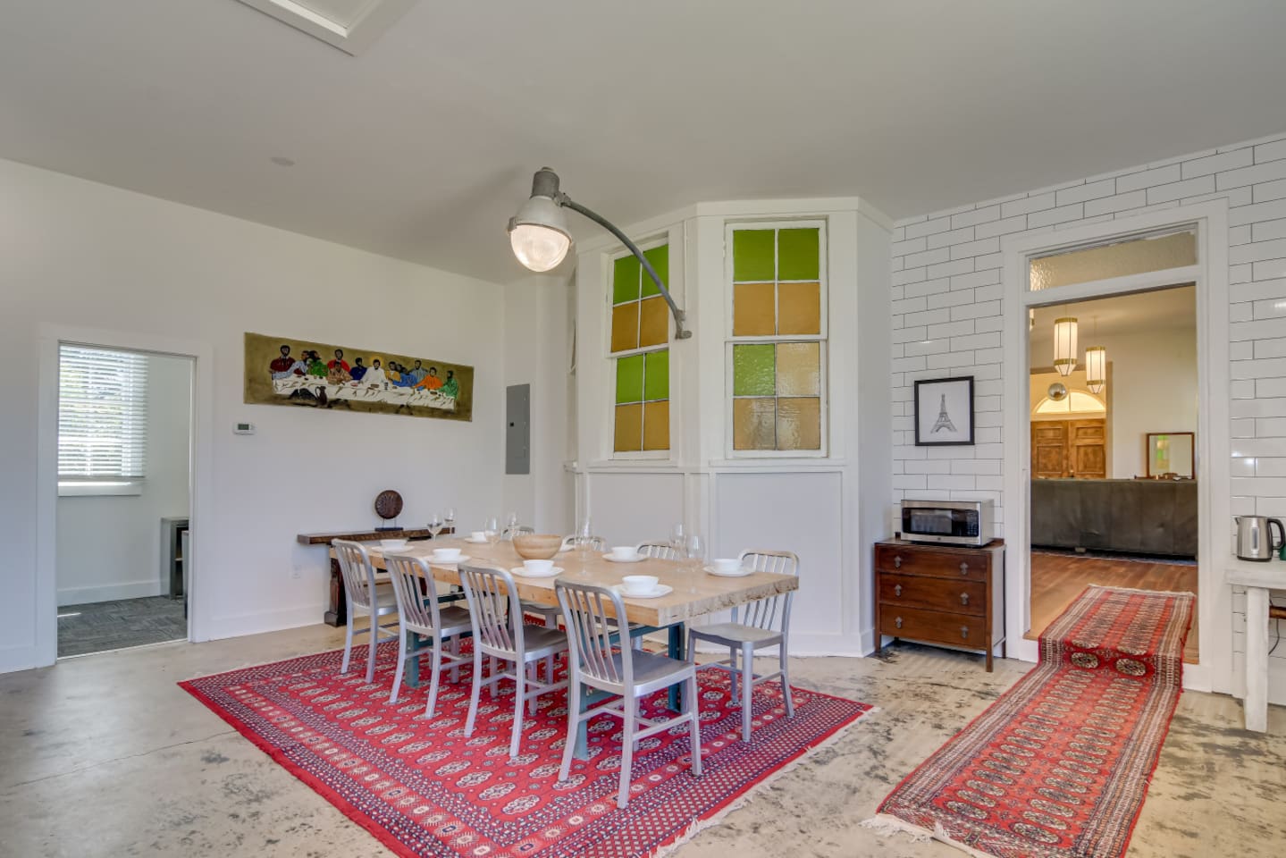 Dining space with seating for eight and warm lighting.