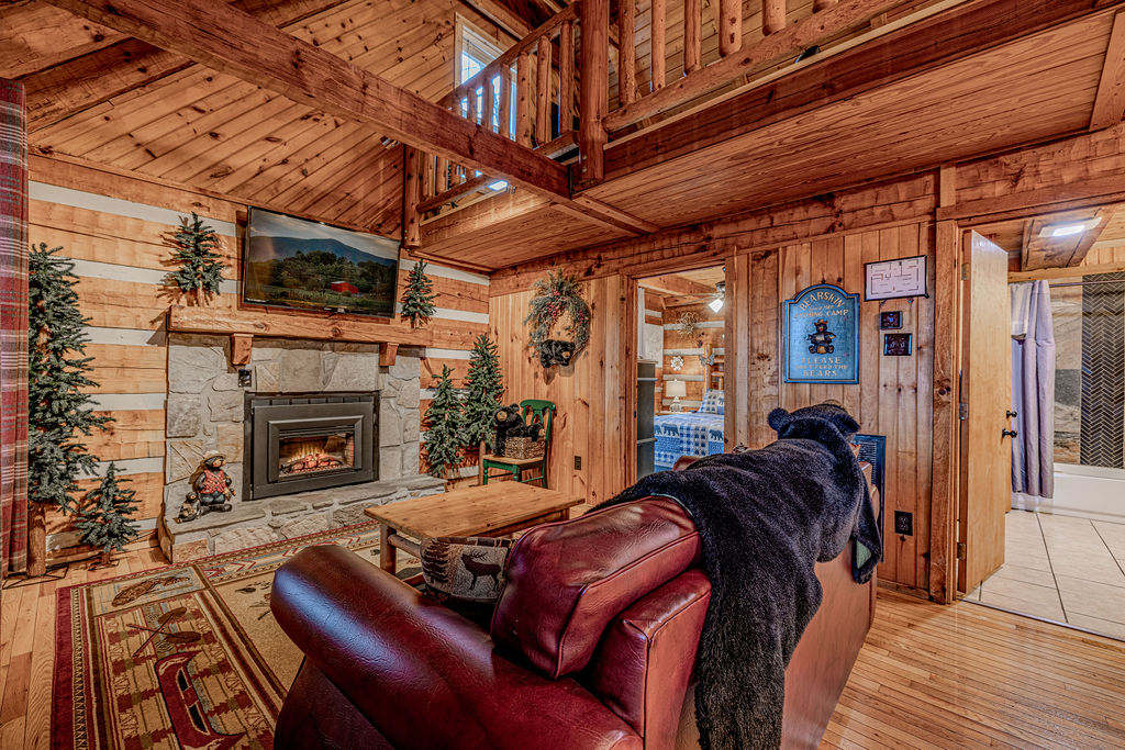 Fireplace and leather couch with mountain art