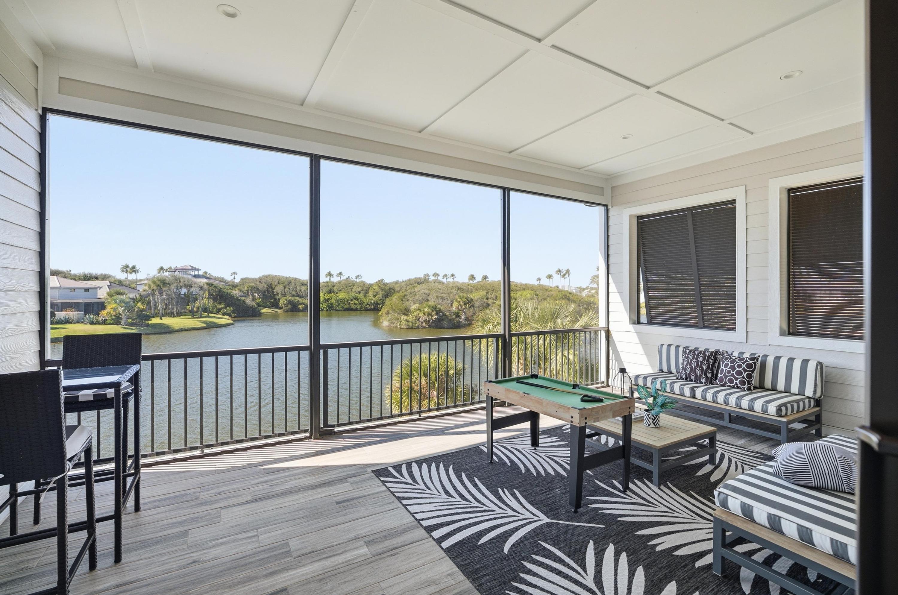 Screened lanai with water views + game time vibes 🌴🎱
Kick back on the comfy lounge seating, sip your morning coffee, and enjoy breezy lake views—then challenge the crew to a round of mini pool for the perfect vacation hangout.