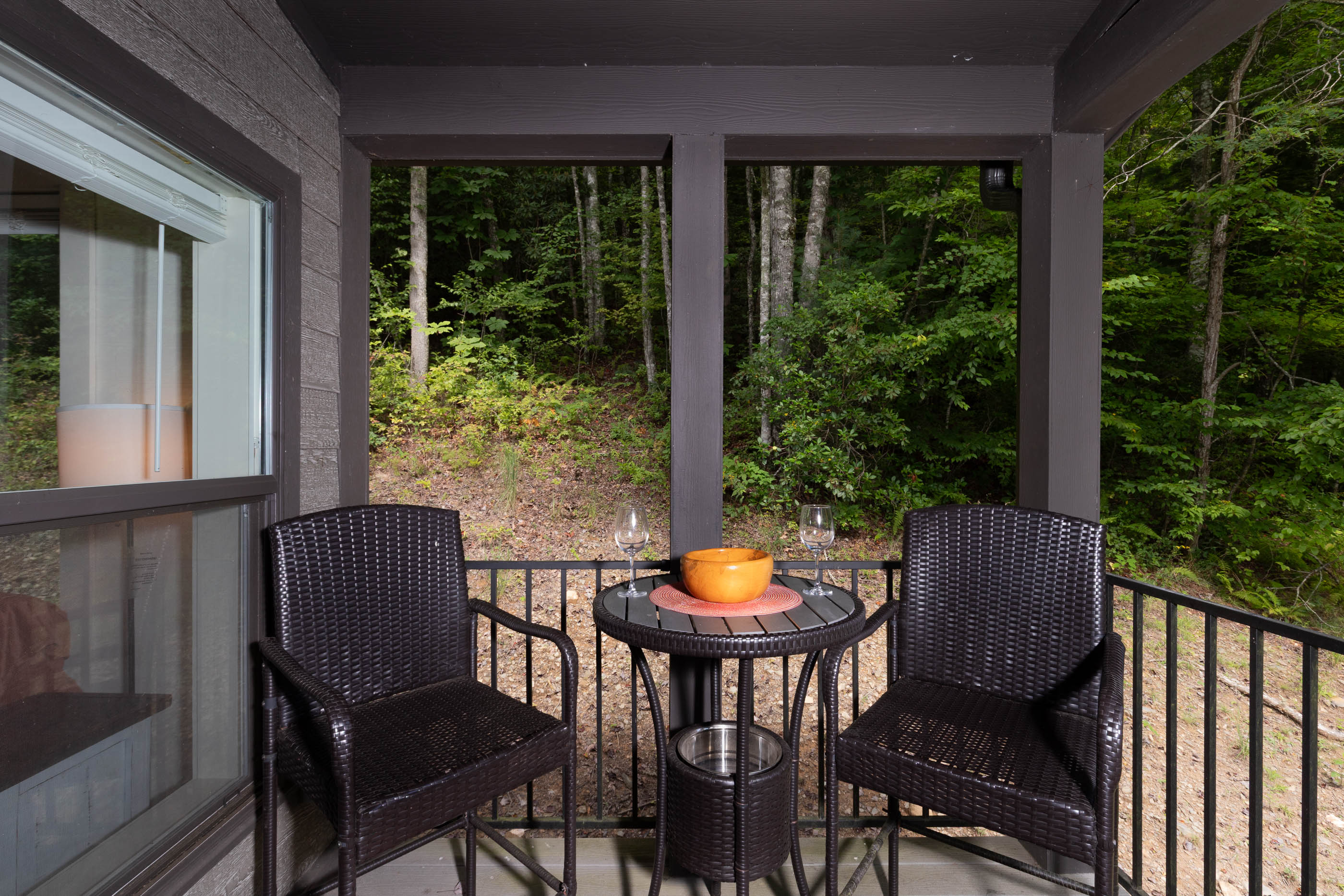 Gather on the covered porch—perfect for evening drinks under the glow of warm lights.