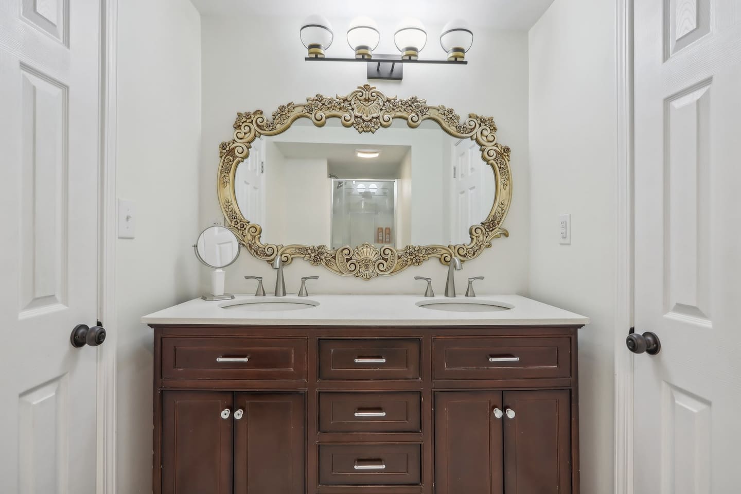 Get ready with ease in full bathroom 3, featuring a double vanity, elegant mirror, and plenty of storage for your essentials.