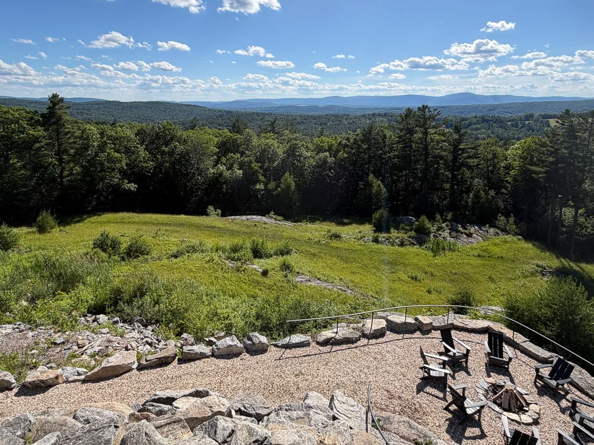 Meadow, rock outcrop, and fire pit above the Berkshires ridgeline &mdash; the 167 acres at Sunset Falls
