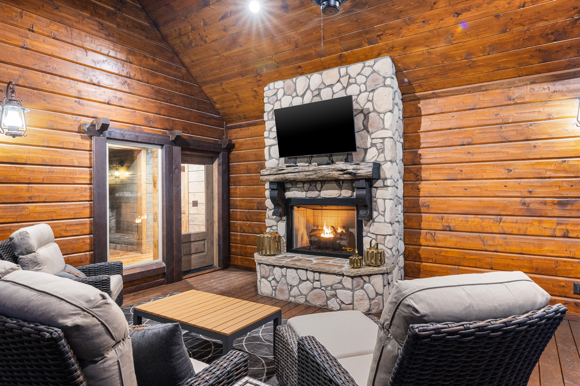 Outdoor lounge with stone fireplace for cozy evenings in the mountains