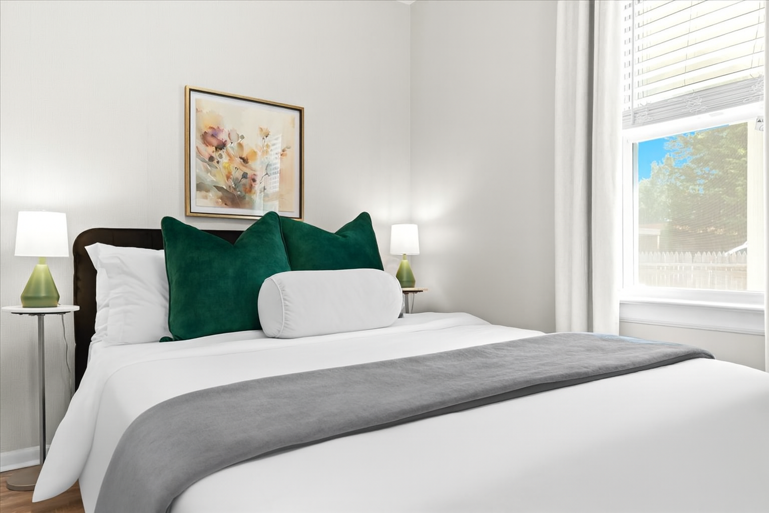 Inviting queen bedroom with fresh décor and nightstand lamps