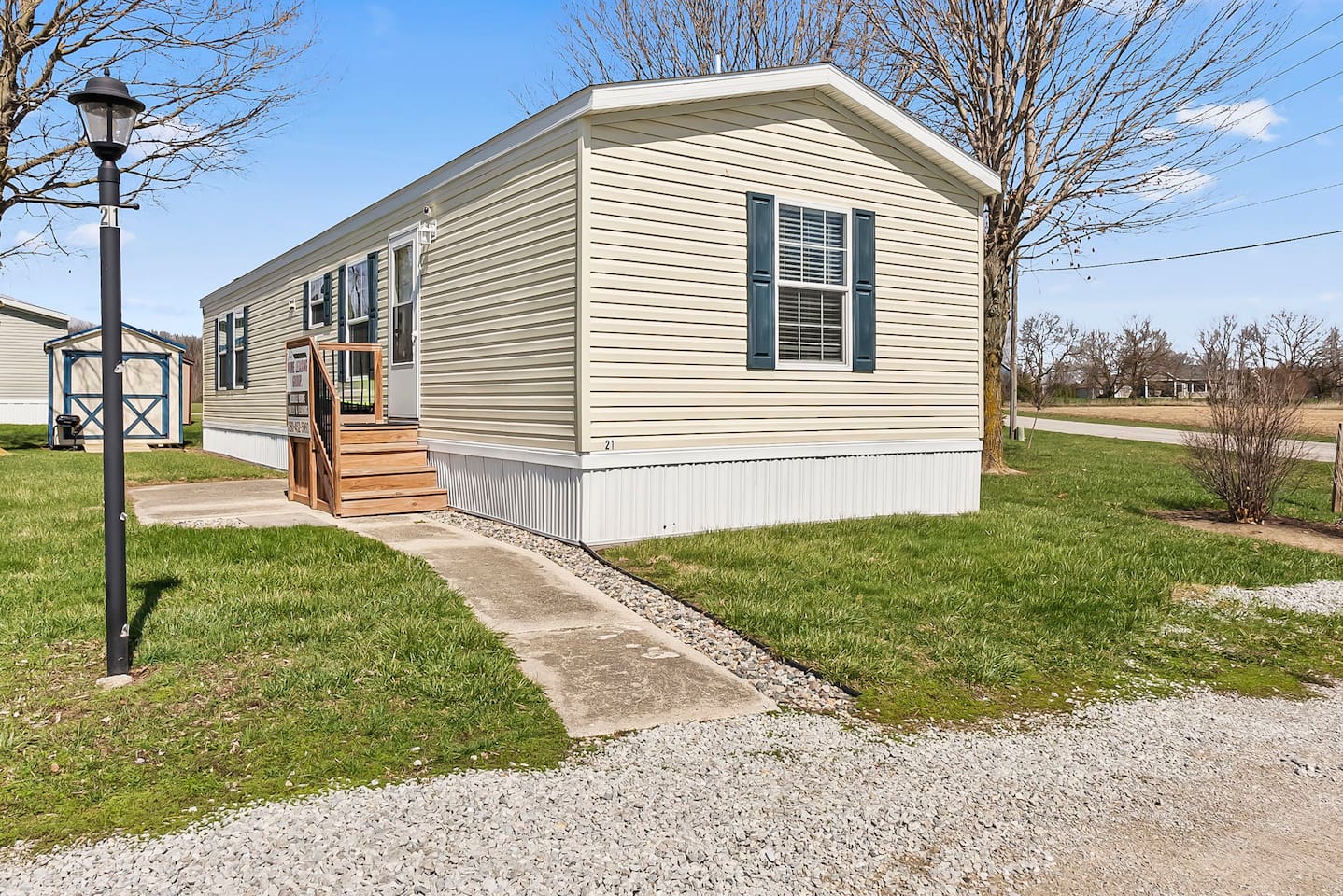 Welcoming exterior of this cozy home with private entrance, green lawn, and easy access walkway.