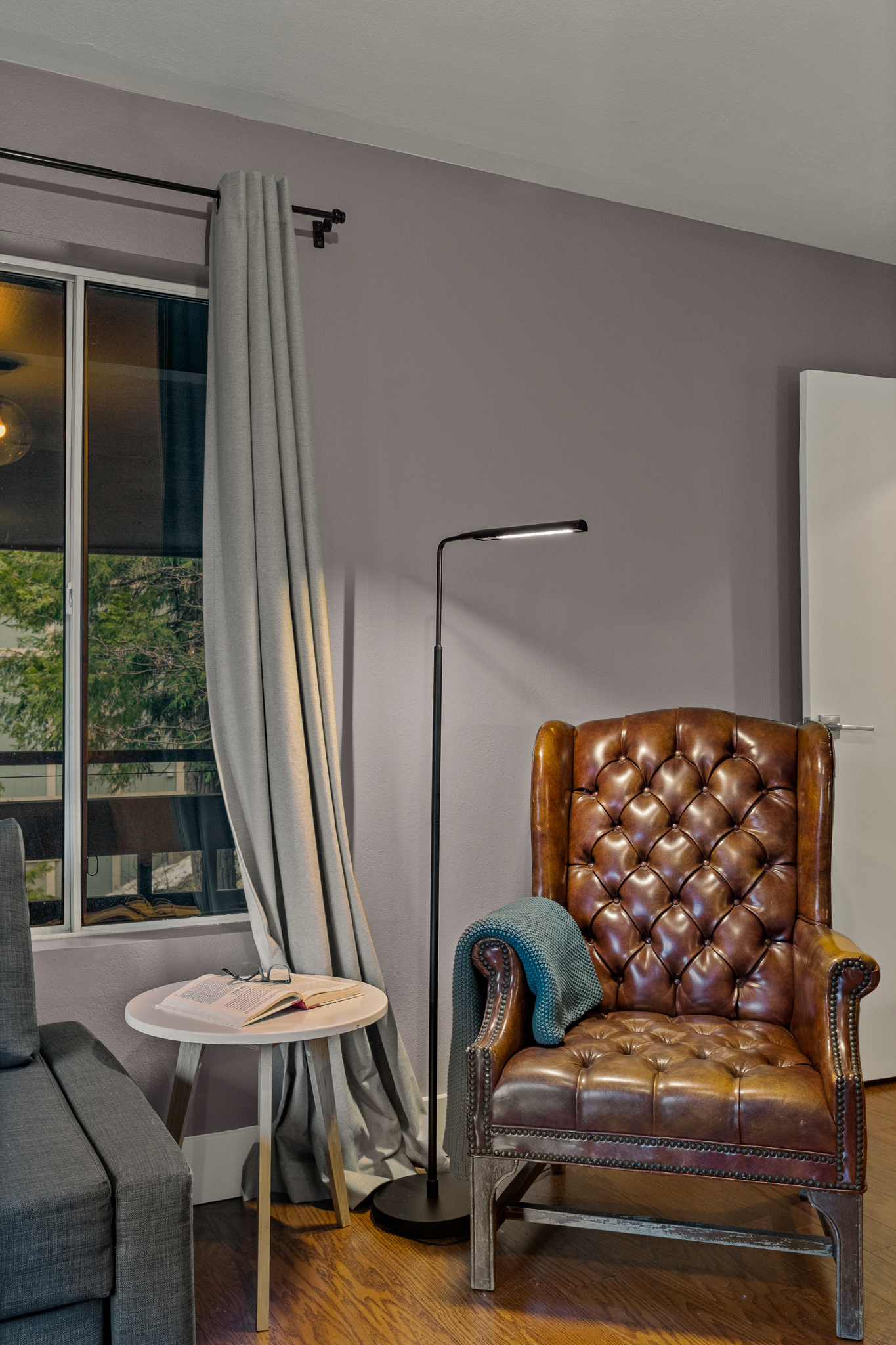 Cozy reading nook with a classic leather chair—perfect for unwinding with a book by the window.