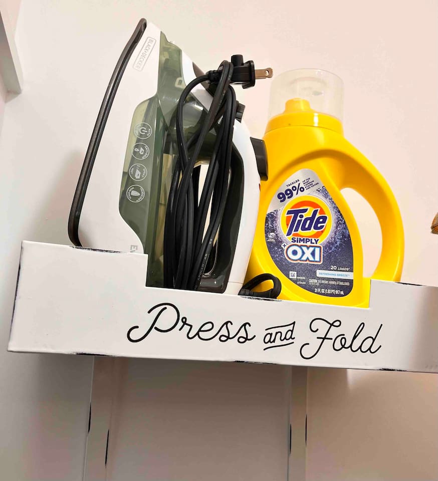 Iron and Ironing board in hallway closet. 