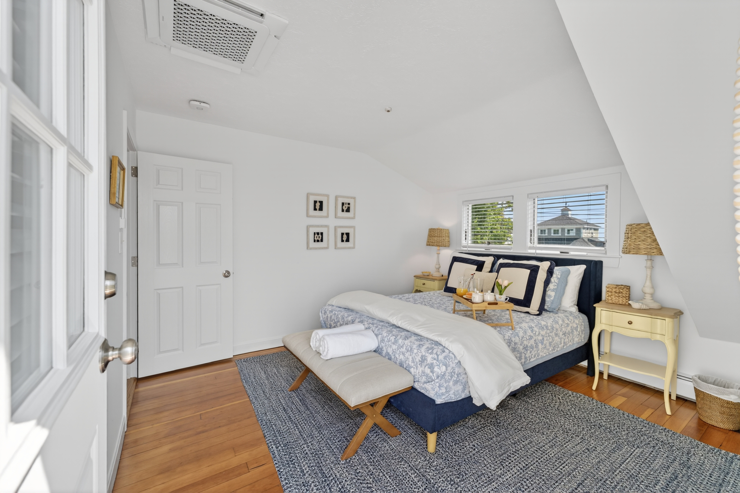 Bright queen bedroom with easy bathroom access and direct entry to the second-floor deck.