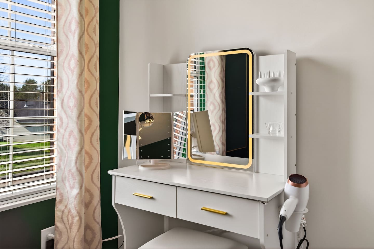 Additional vanity with lighted mirror.