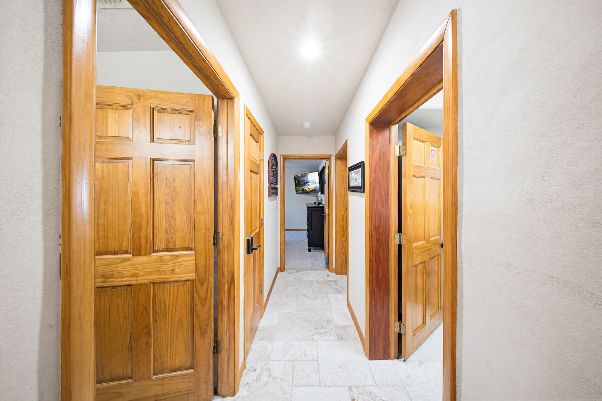 This hall gives access to the second bathroom, the laundry room, and two more bedrooms.