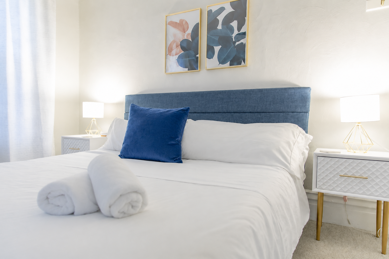 Discover the King Bedroom, a spacious room on the second floor with king bed flanked by nightstands with lamps.