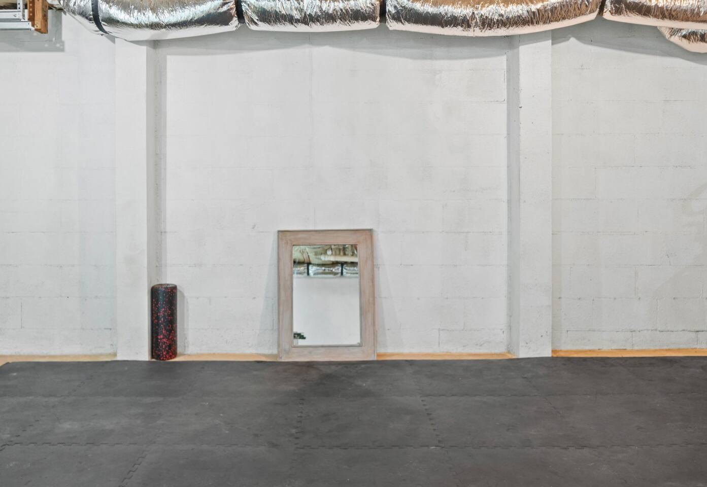 Large area in unfinished basement with foam mats