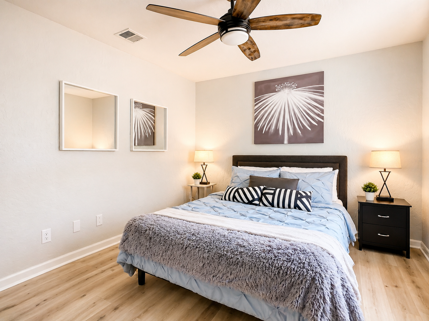 Bright living space with sliding glass doors, comfortable seating area, and contemporary lighting design.
