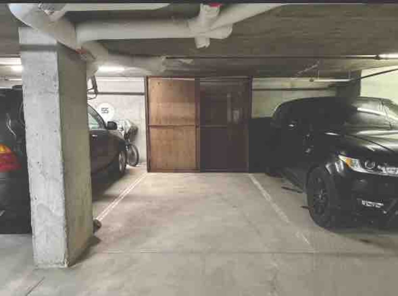 Secure private parking stall with bike & equipment storage cage