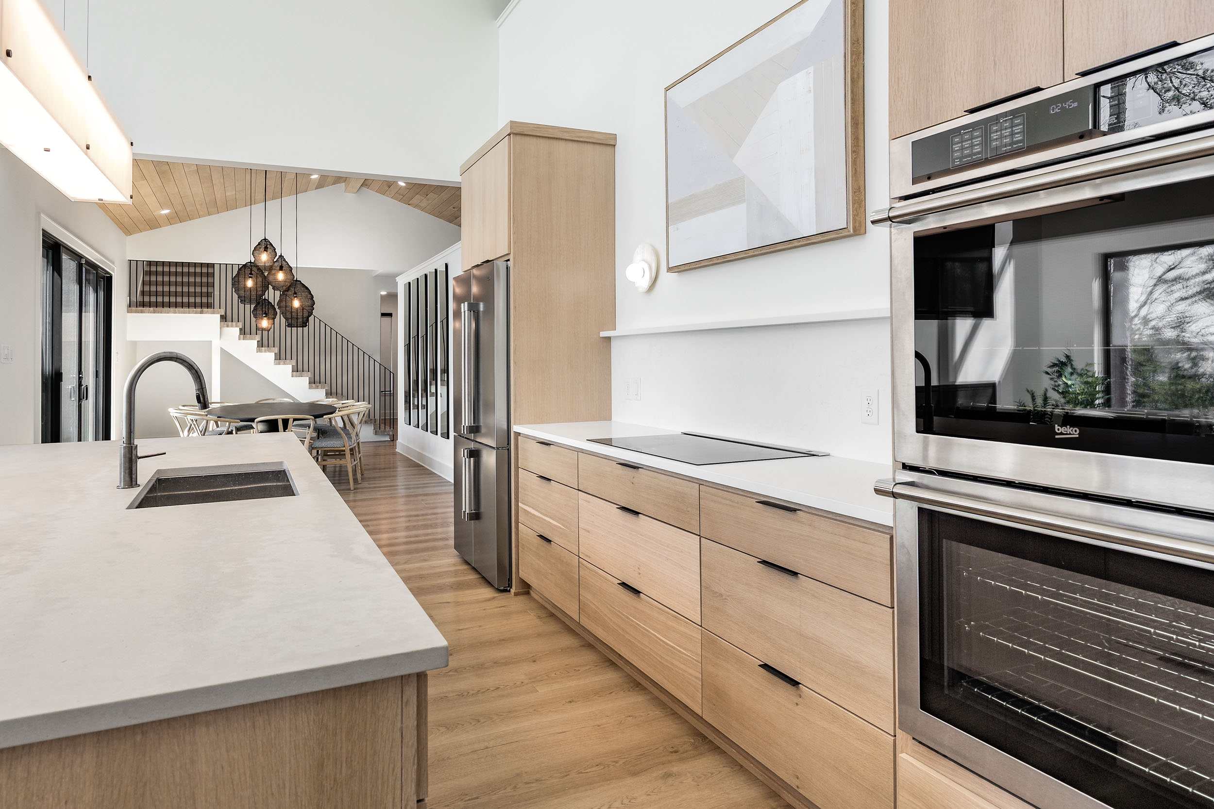 This sleek, modern kitchen is fully equipped with high-end appliances and spacious countertops for preparing group meals with ease. 