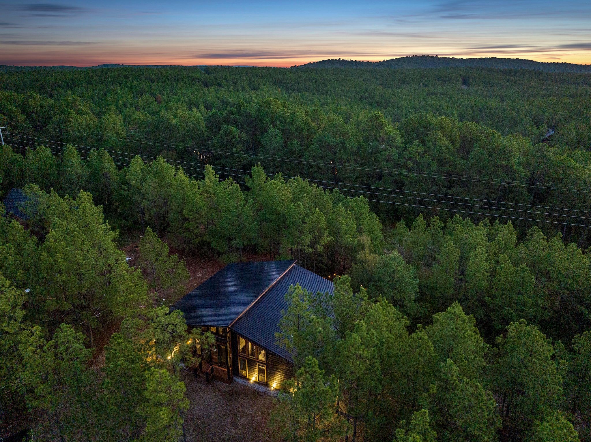 Private forest cabin with panoramic views and glowing evening skies