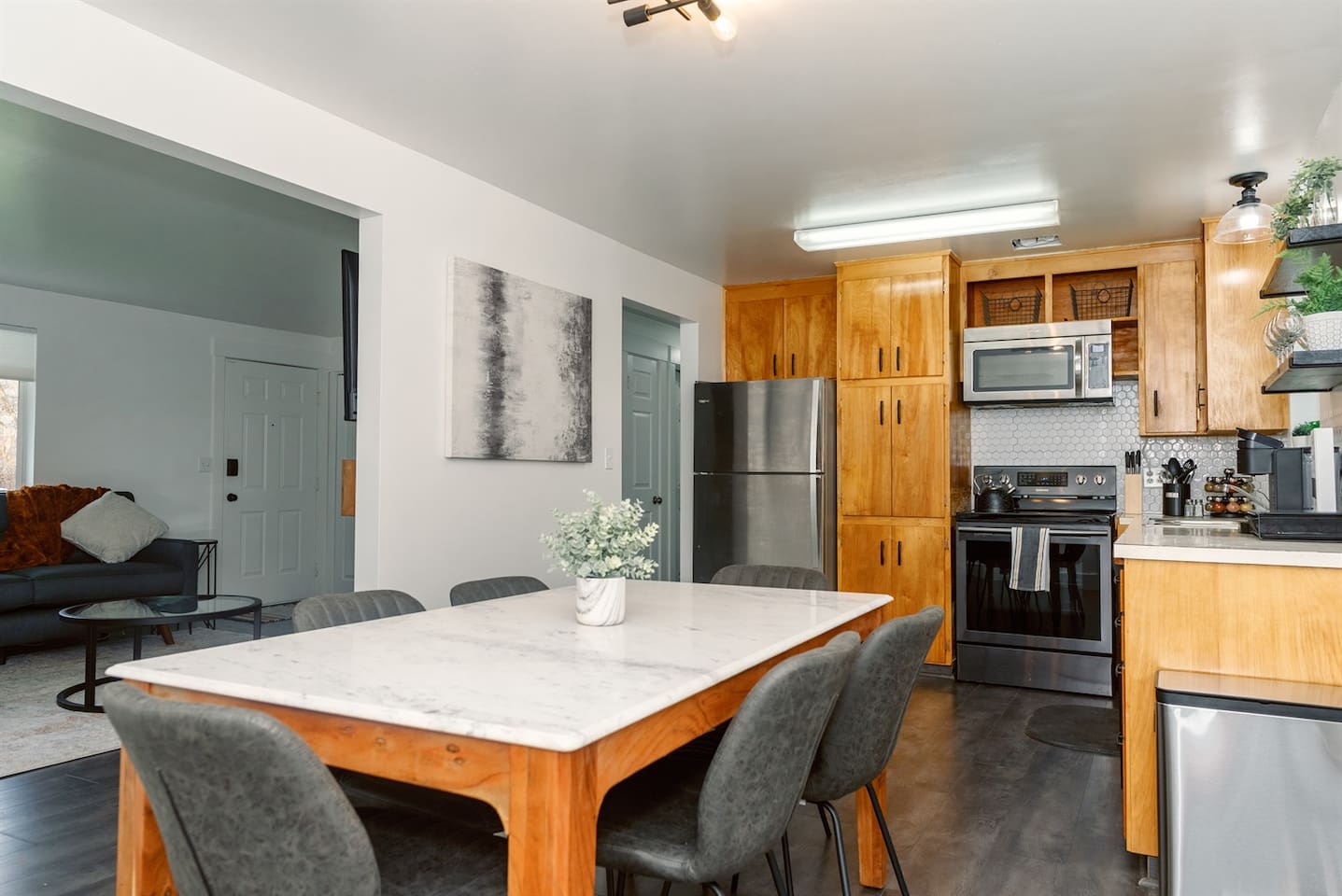 Large kitchen with original 1960s cabinets and dining space for six. The in unit w/d is in the closet just off the dining room.