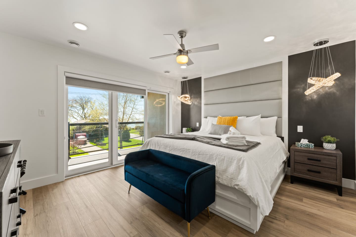 Master bedroom with king bed and Floor-to-ceiling windows framing the city skyline