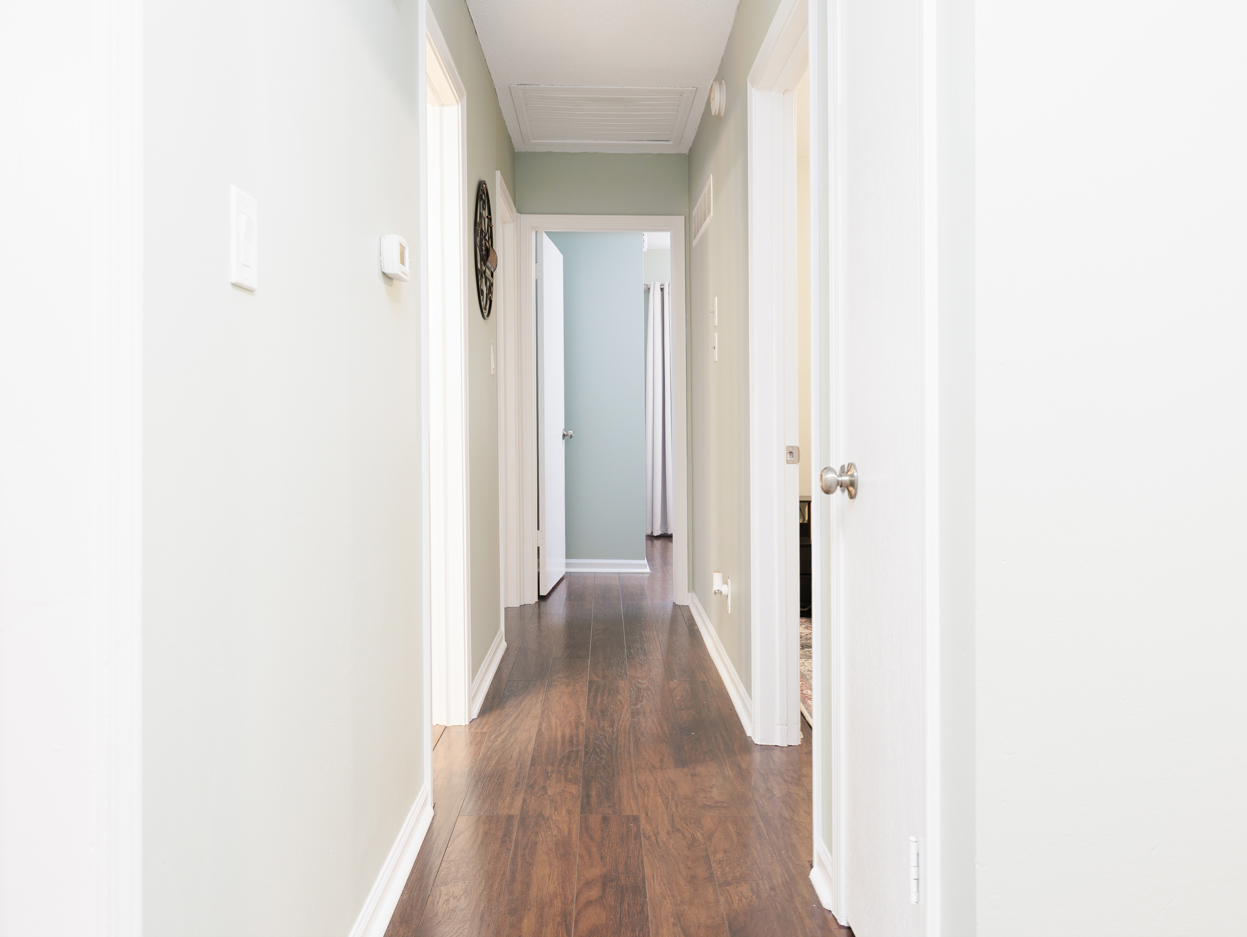 Clean, well-lit hallway connecting bedrooms and main living spaces for easy flow throughout the home.